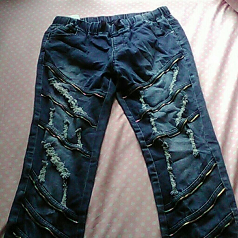 Blue jeans with rips and zippers